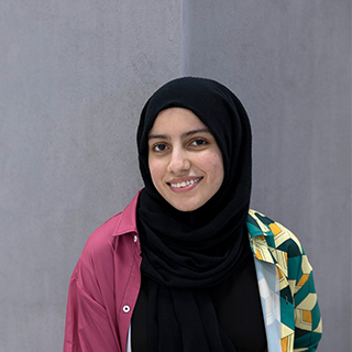 A student smiling at the camera