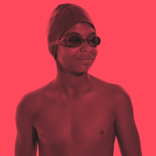 Child wearing a swimming cap and swimming goggles.